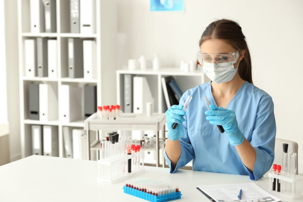 Woman in lab with test tubes
